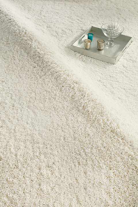 close up view of light beige textured rug